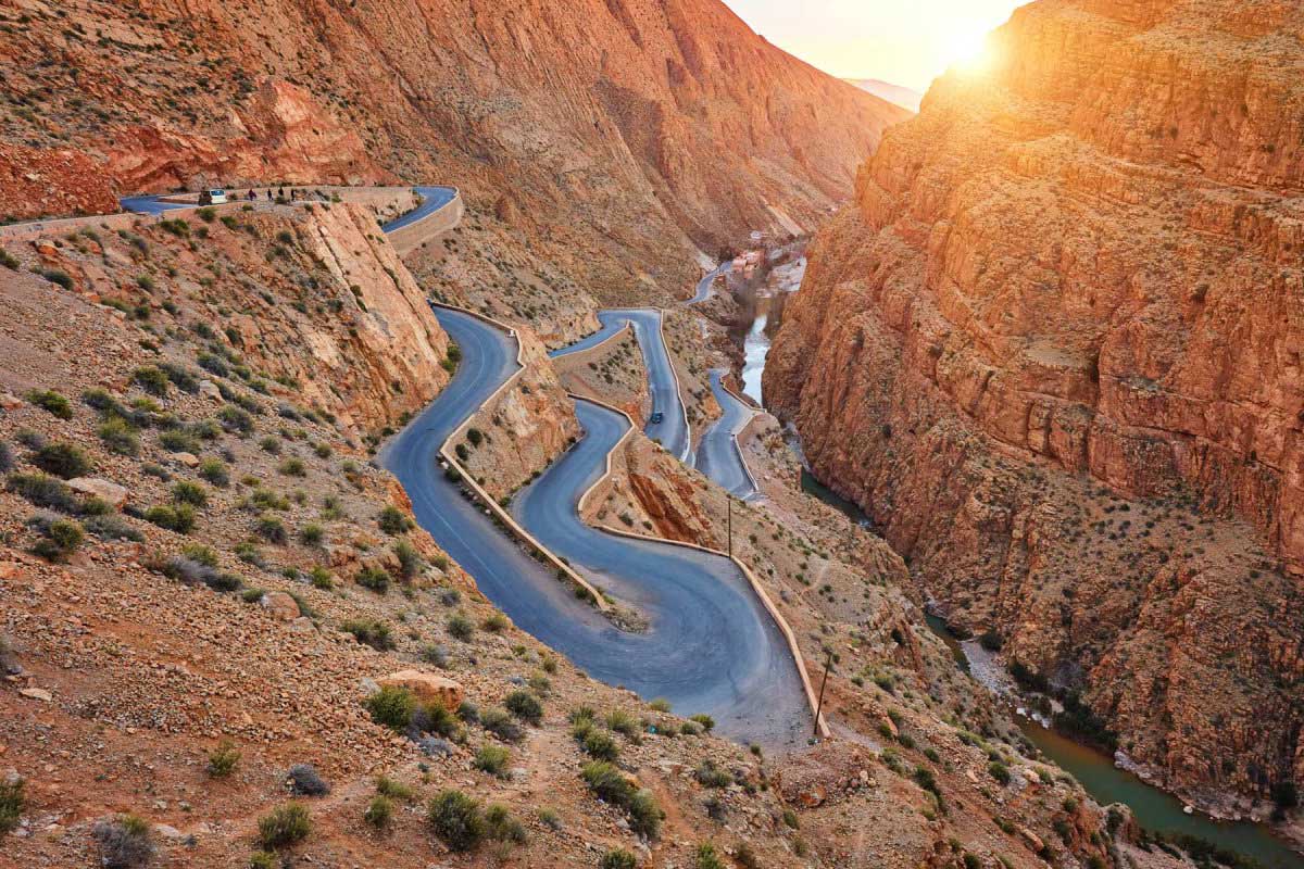 The famous hairpin switchbacks of the Dades Gorge glow at sunset — seen on Day 1 of the Marrakech to Casablanca route.