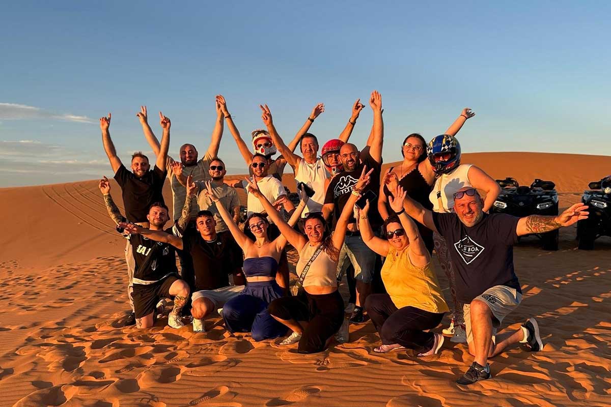 New friends on the Sahara: our small group celebrating sunset on the Erg Chebbi dunes near Merzouga.